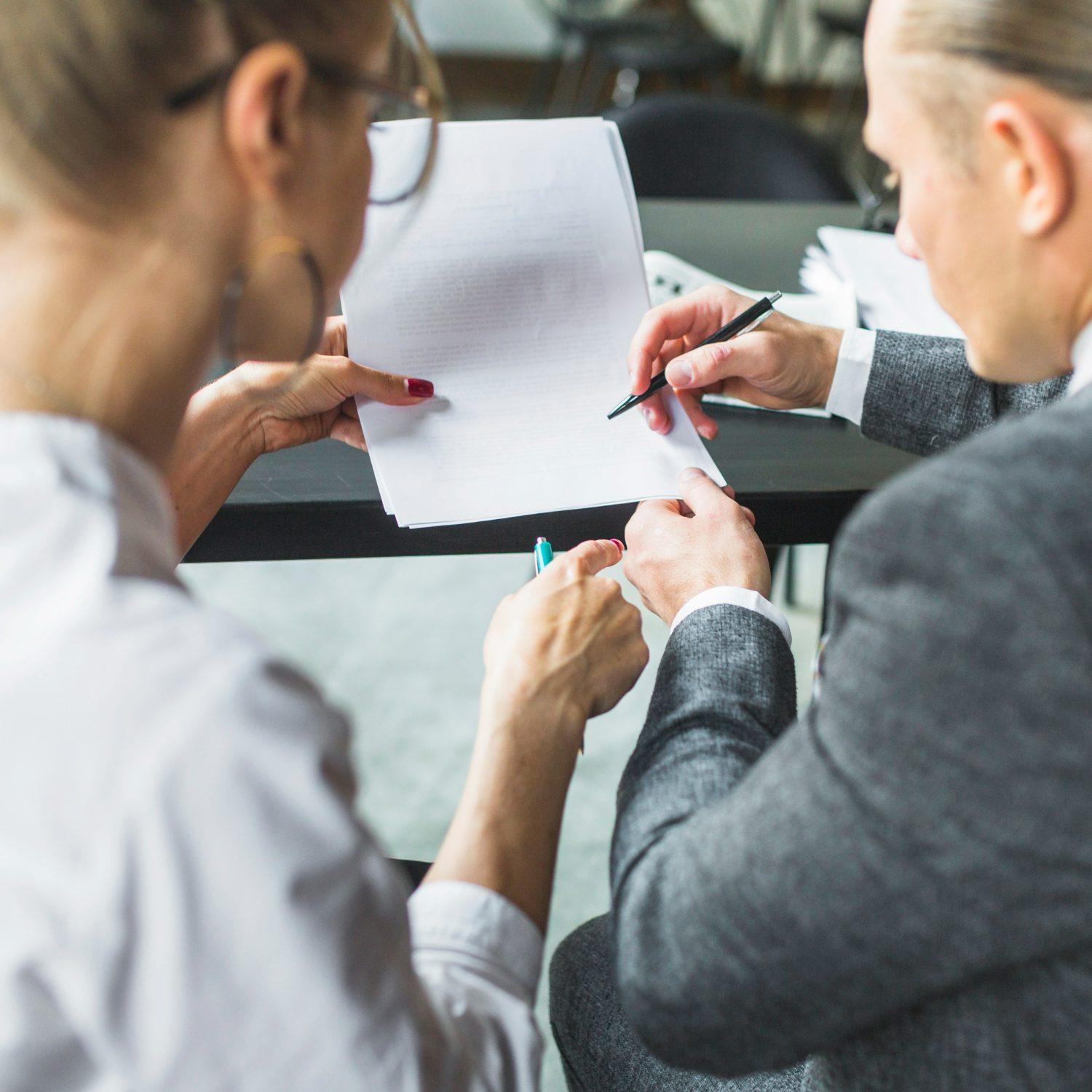 close-up-two-businesspeople-checking-document-restaurant